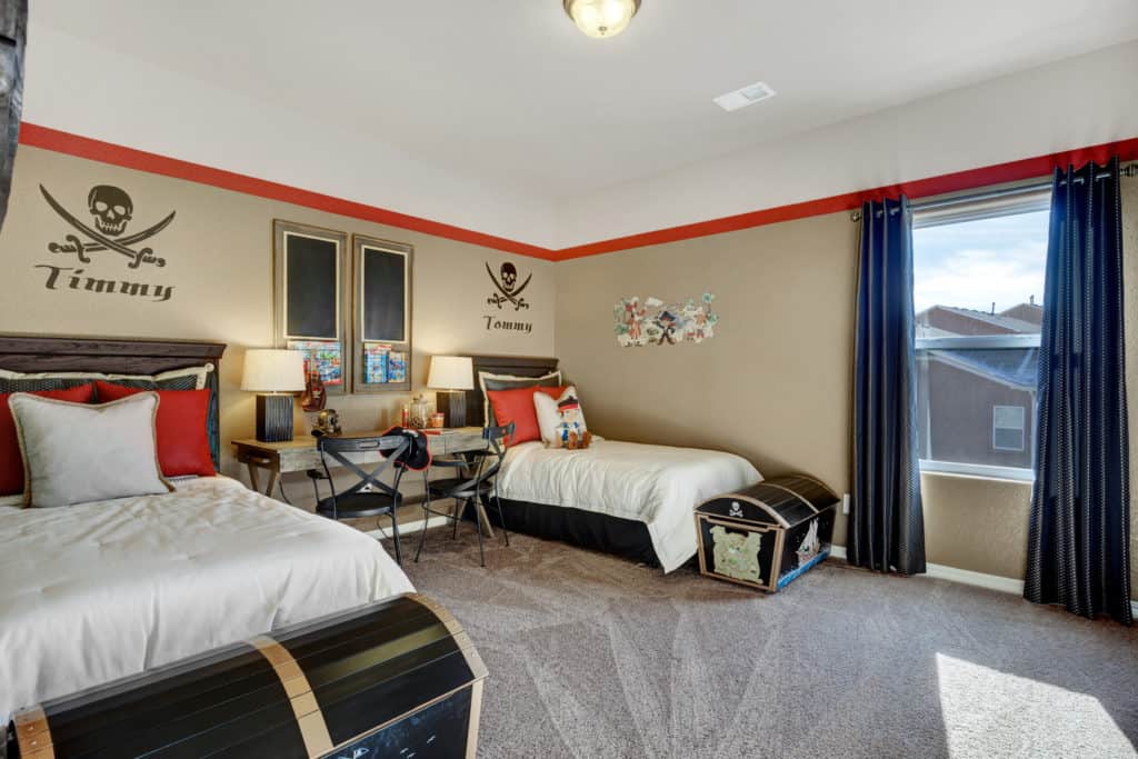 a photo of a bedroom with two twin beds and a pirate theme