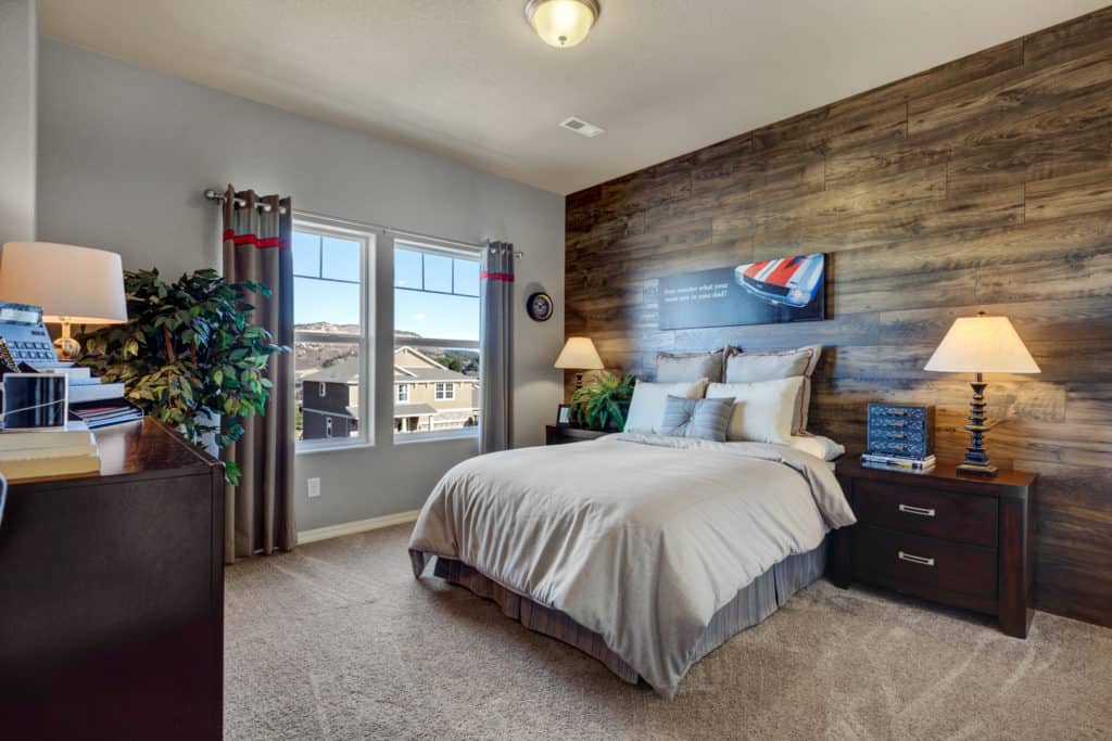 a photo of a bedroom with a wood accent wall