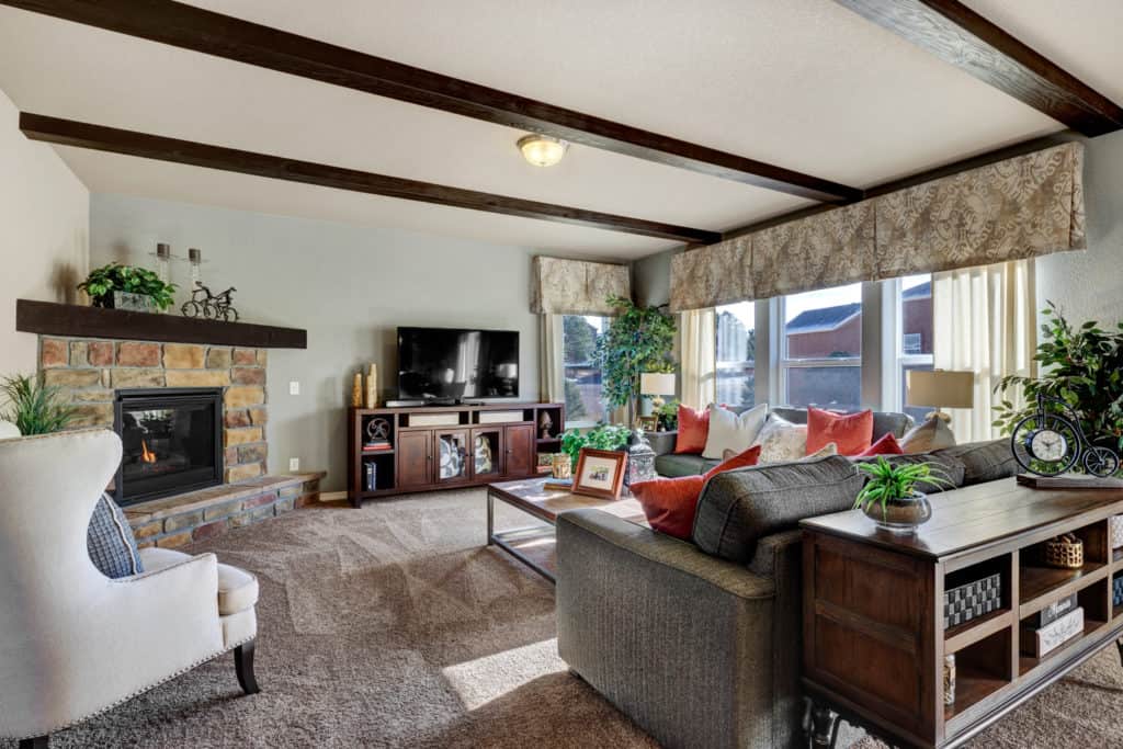a photo of interior design family room with wood ceiling beams